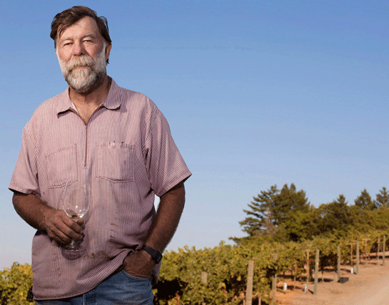 Stuart Smith with vineyard in background